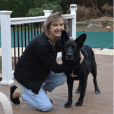 Woman with black German Shepherd dog